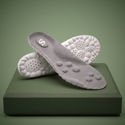 Pair of Solacea plantar fasciitis insoles on a sage plinth, showing the cushioned massage domes and deep heel cup