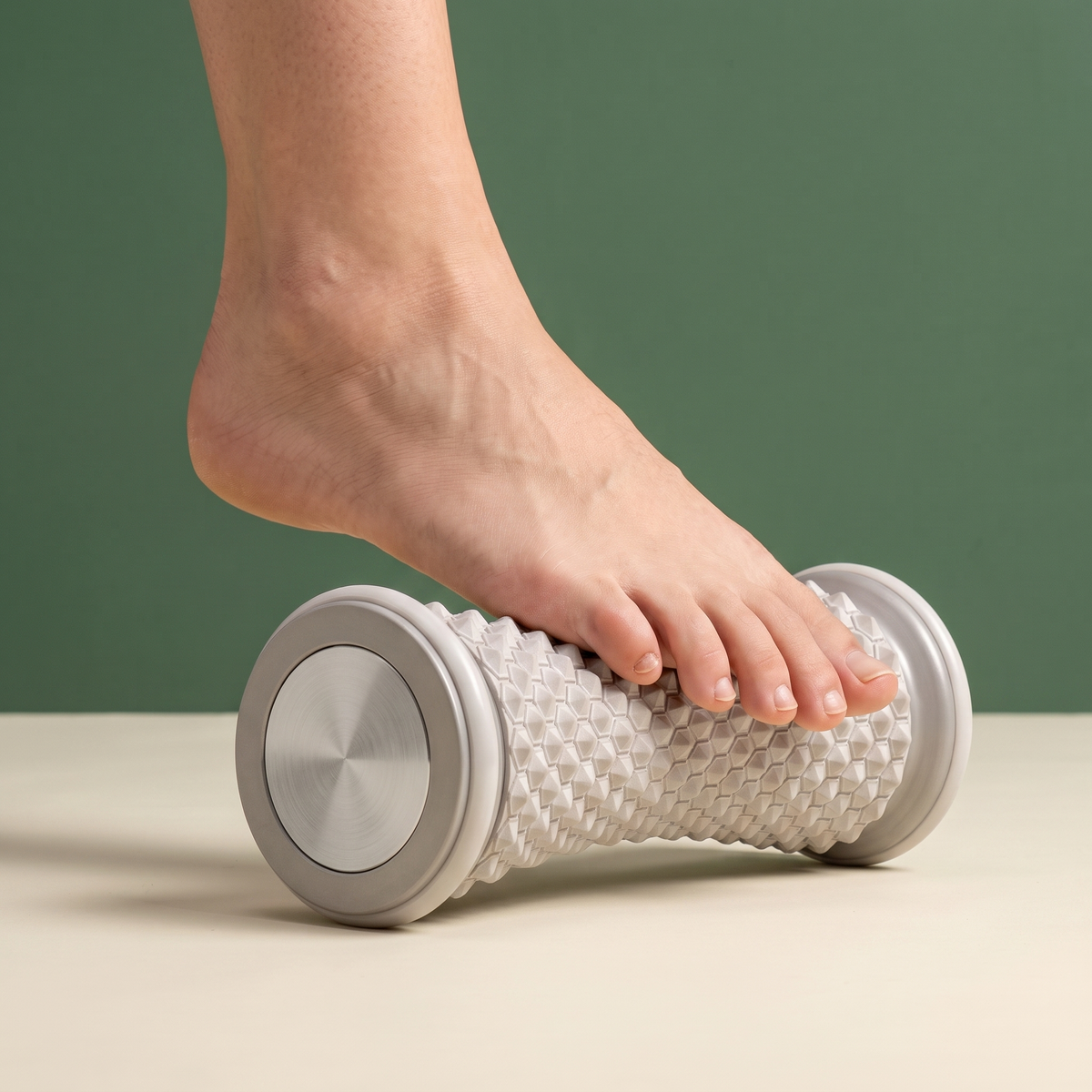 Bare foot rolling the ball of the foot on the Solacea foot massage roller